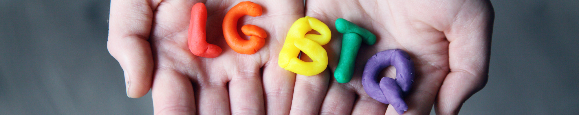 hands open holding letters that spell LGBTQ